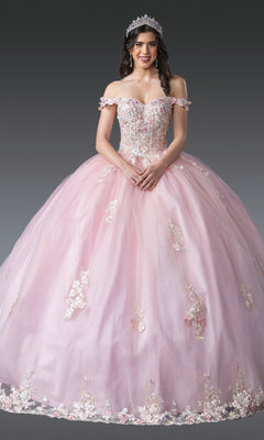 A woman wearing the Quinceanera Dress 1906 By Dancing Queen in blush, featuring an off-the-shoulder design with 3D floral appliques and a tiara, stands against a plain gray background.