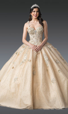 A woman stands against a gray background wearing the Quinceanera Dress 1915 By Dancing Queen, an ornate light gold glitter tulle ball gown with floral embroidery, a corset bodice, and a tiara.