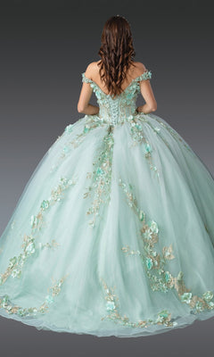 A woman faces away from the camera in the Quinceanera Dress 1918 By Dancing Queen, a mint green ball gown with floral embroidery and a corset bodice, set against a gray background.