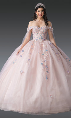 A woman stands against a gray background wearing the Quinceanera Dress 1919 By Dancing Queen—an off-the-shoulder pink gown with 3D flowers, a tiara, and a glitter tulle skirt.