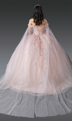 A woman shown from the back wears Quinceanera Dress 1919 by Dancing Queen—an off-the-shoulder, light pink gown with 3D flowers and a long glitter tulle train.