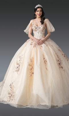 A young woman wears the Quinceanera Dress 1926 By Dancing Queen—a champagne ball gown with sequin lace embroidery, off-the-shoulder sleeves, and a beaded tiara—standing against a gray background.