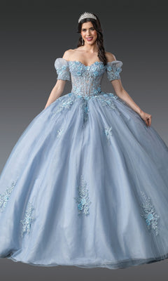 A woman wearing the Quinceanera Dress 1932 By Dancing Queen, featuring blue floral embroidery, off-the-shoulder sleeves, a corset bodice, and a tiara, stands against a gray background.