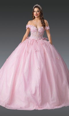 A woman in the Quinceanera Dress 1933 by Dancing Queen, a light pink off-the-shoulder gown with 3D floral appliqués and a tiara, stands against a gray background.