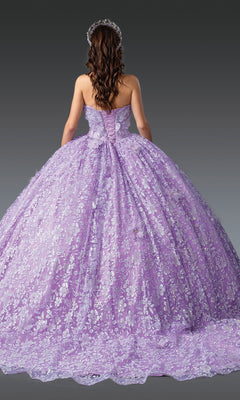 A woman with long brown hair models the Quinceanera Dress 1940 By Dancing Queen—a strapless lilac gown with silver floral patterns and 3D flowers, plus a matching tiara—shown from the back against a gray background.