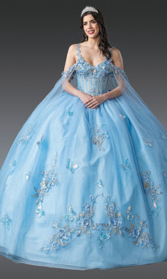 Smiling woman wearing the Blue Quinceanera Dress 1942 By Dancing Queen, a light blue gown with delicate embellishments and a tiara, posing against a plain gray background.