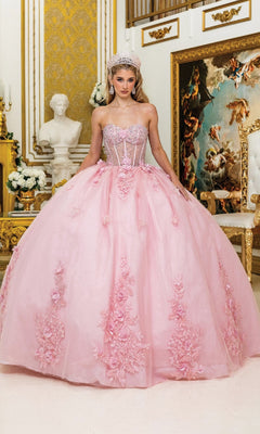 Woman in a pink ball gown standing in an ornate room with gold accents and decorative mirrors.