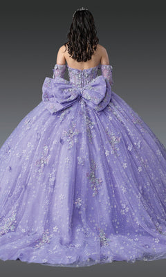 A woman faces away, wearing the Quinceanera Dress 1965 By Dancing Queen—a floor-length lavender gown with floral embroidery, off-the-shoulder sleeves, and a large bow at the back.