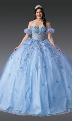 A woman wearing the Blue Quinceanera Dress 1969 By Dancing Queen and a tiara stands against a plain gray background.