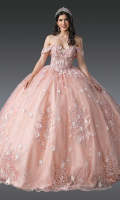 A woman in the Quinceanera Dress 1971 by Dancing Queen, featuring blush pink fabric and 3D flower embellishments, poses with a tiara against a plain gray background.