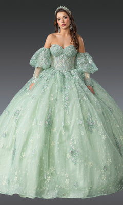 A woman in the Quinceanera Dress 1973 By Dancing Queen, featuring a light green off-the-shoulder corset bodice, floral embroidery, and puff sleeves, stands against a plain dark background.