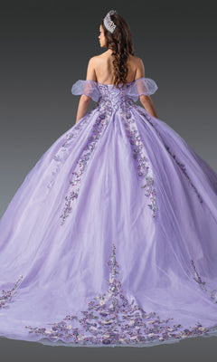 A woman in the Lilac Quinceanera Dress 1977 By Dancing Queen, featuring beaded embroidery and an off-the-shoulder glitter tulle ball gown design, stands facing away to showcase its full skirt and elegant style.
