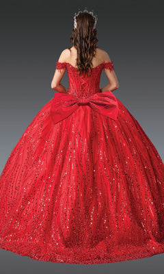 A person in the Long Corset Quinceañera Dress: Dancing Queen 1982, a floor-length sequin-embellished ball gown with a large back bow and jeweled hair accessory, is facing away from the camera.