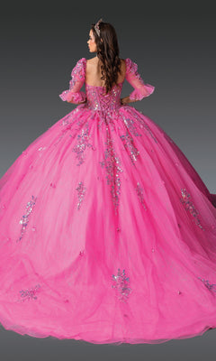 A woman faces away in the Pink Quinceanera Dress 1995 by Dancing Queen, featuring voluminous pink glitter tulle, sequin floral embroidery, and puff sleeves against a plain dark background.