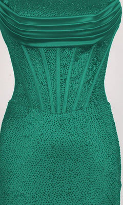 A close-up of the PromGirl Exclusive 250217, a long emerald green strapless prom dress with a structured, vertically boned bodice, sparkling embellishments, and a chic lace-up back.