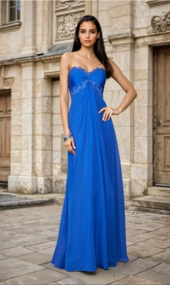 A woman stands outdoors in front of a stone building, wearing the Strapless Long A-Line Prom Dress La Femme 20042 in royal blue with decorative embroidery across the bodice.