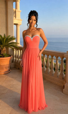 A woman stands on a balcony overlooking the ocean in a Pink Grapefruit Strapless Sweetheart Prom Gown, La Femme 20048, featuring a jeweled neckline.