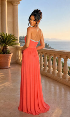 Woman in the Strapless Sweetheart Prom Gown: La Femme 20048—with jeweled detail—stands on a balcony above the sea, surrounded by potted plants and a stone railing.