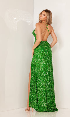 Woman wearing the Strappy-Back Long Sequin Prom Dress: Aleta 200A, featuring green sequins and thin straps, stands in a plain white room, facing sideways and smiling over her shoulder.