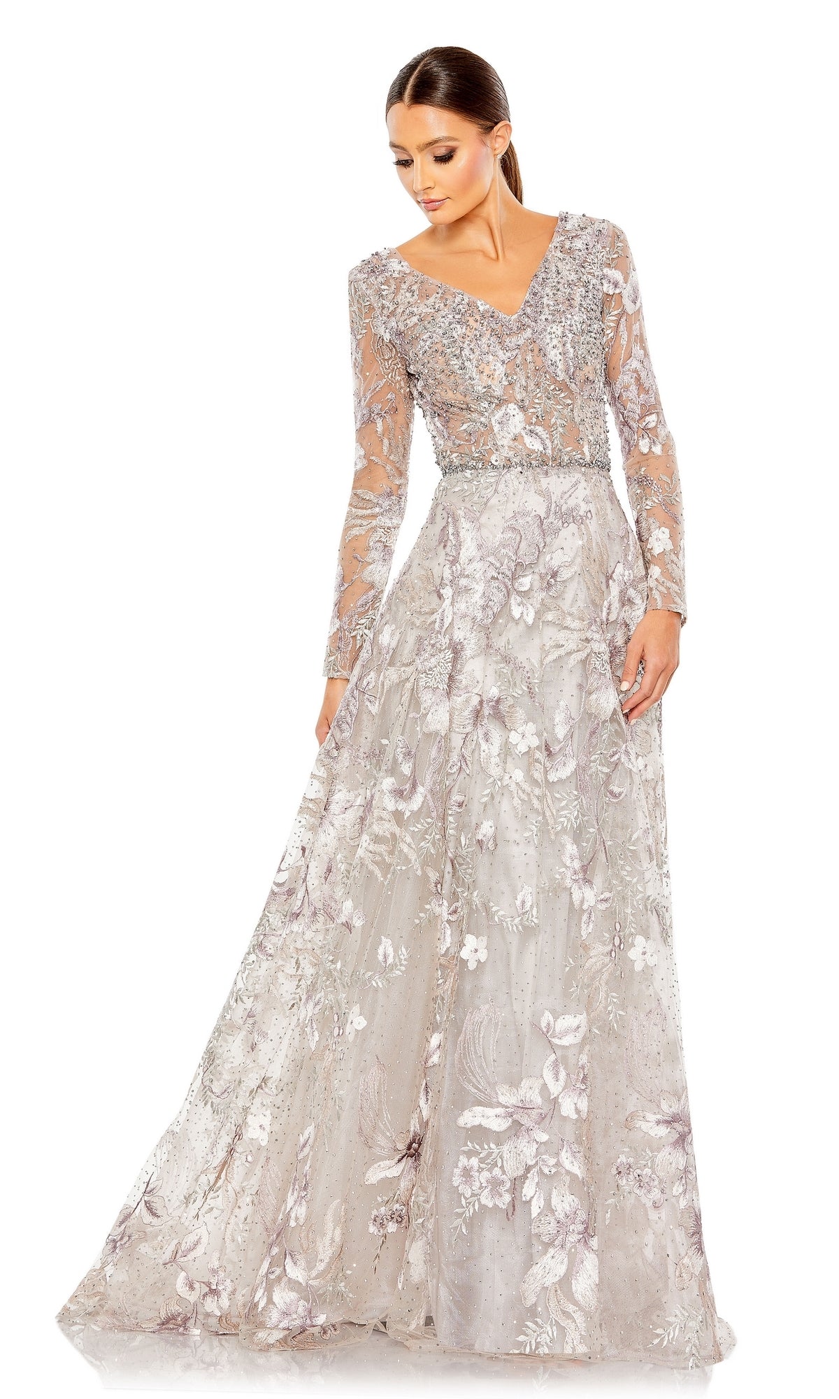 A woman in the Mac Duggal 20214 Long Sleeve Long Formal Dress with floral embroidery, sheer sleeves, and a V-neckline looks down and to the side—embodying timeless elegance.