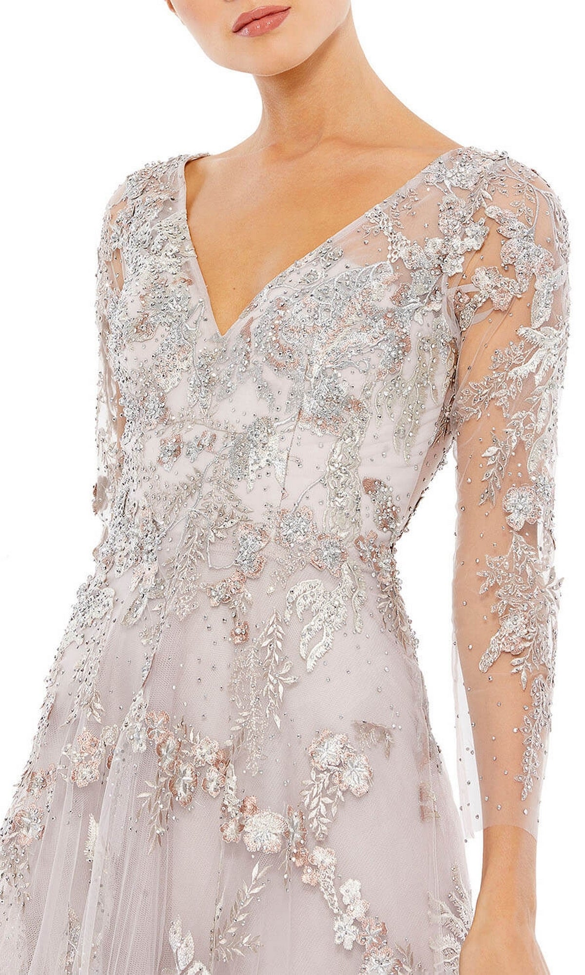 A woman wears the Long Violet Lace Formal Dress by Mac Duggal (style 20245), featuring sheer long sleeves and delicate silver floral embroidery with beadwork, radiating timeless elegance.