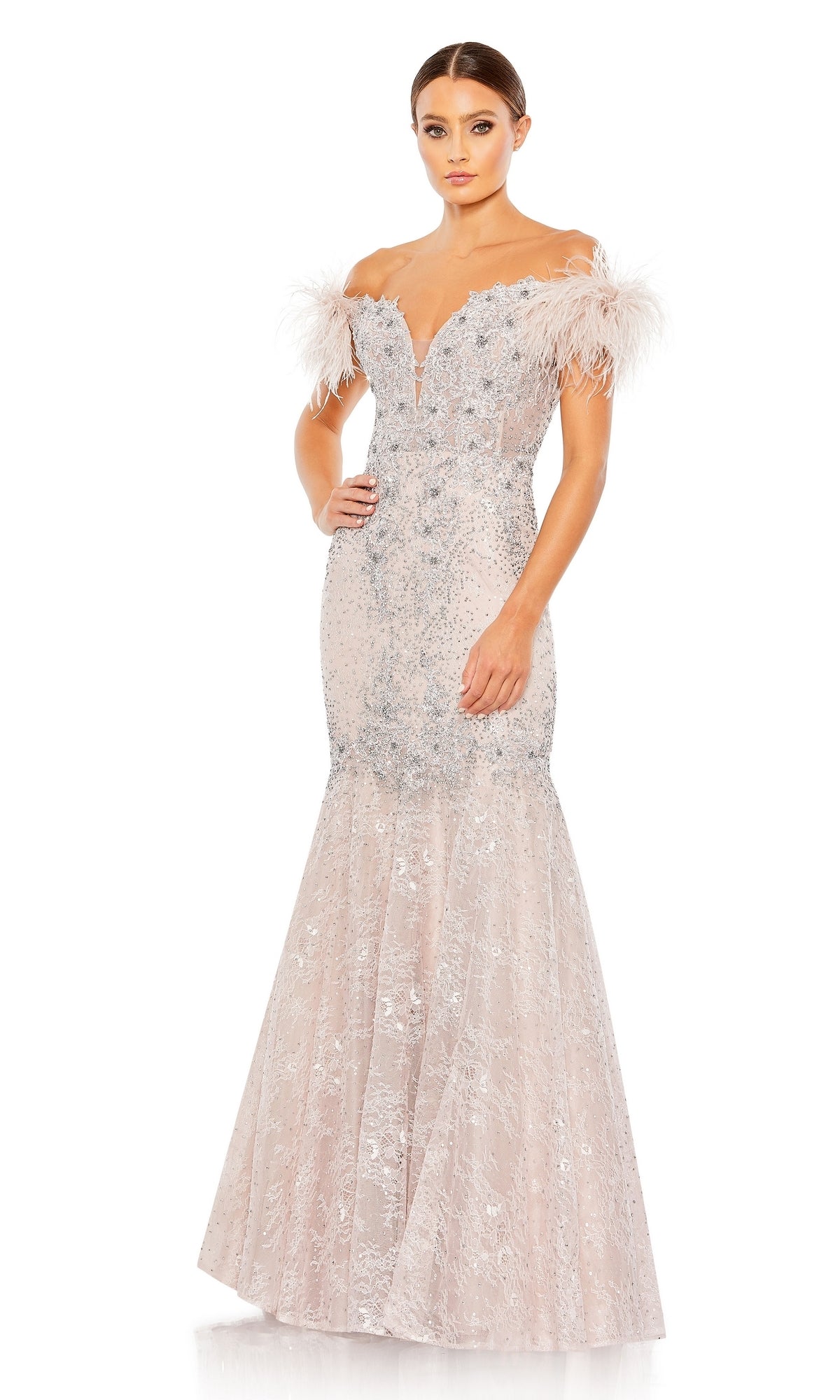 A woman models the Mac Duggal 20246 Off-Shoulder Long Formal Dress, featuring silver beading, feathered sleeves, and a flared lace mermaid skirt, elegantly posed against a white background.