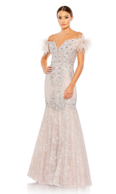 A woman models the Mac Duggal 20246 Off-Shoulder Long Formal Dress, featuring silver beading, feathered sleeves, and a flared lace mermaid skirt, elegantly posed against a white background.