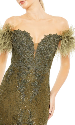 Woman wearing the Mac Duggal 20246 off-shoulder long formal dress in olive green, featuring sequin embellishments, mermaid silhouette, and feathered sleeve details.
