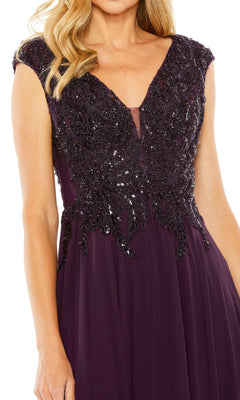 A woman in the Mac Duggal 20264 Beaded-Bodice Long Formal Dress, featuring a sleeveless deep purple A-line silhouette and an intricately beaded v-neck bodice.