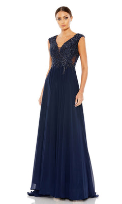 A woman models the Mac Duggal 20264 Beaded-Bodice Long Formal Dress, featuring a navy blue A-line silhouette, beaded V-neck bodice, and cap sleeves, standing against a plain white background.
