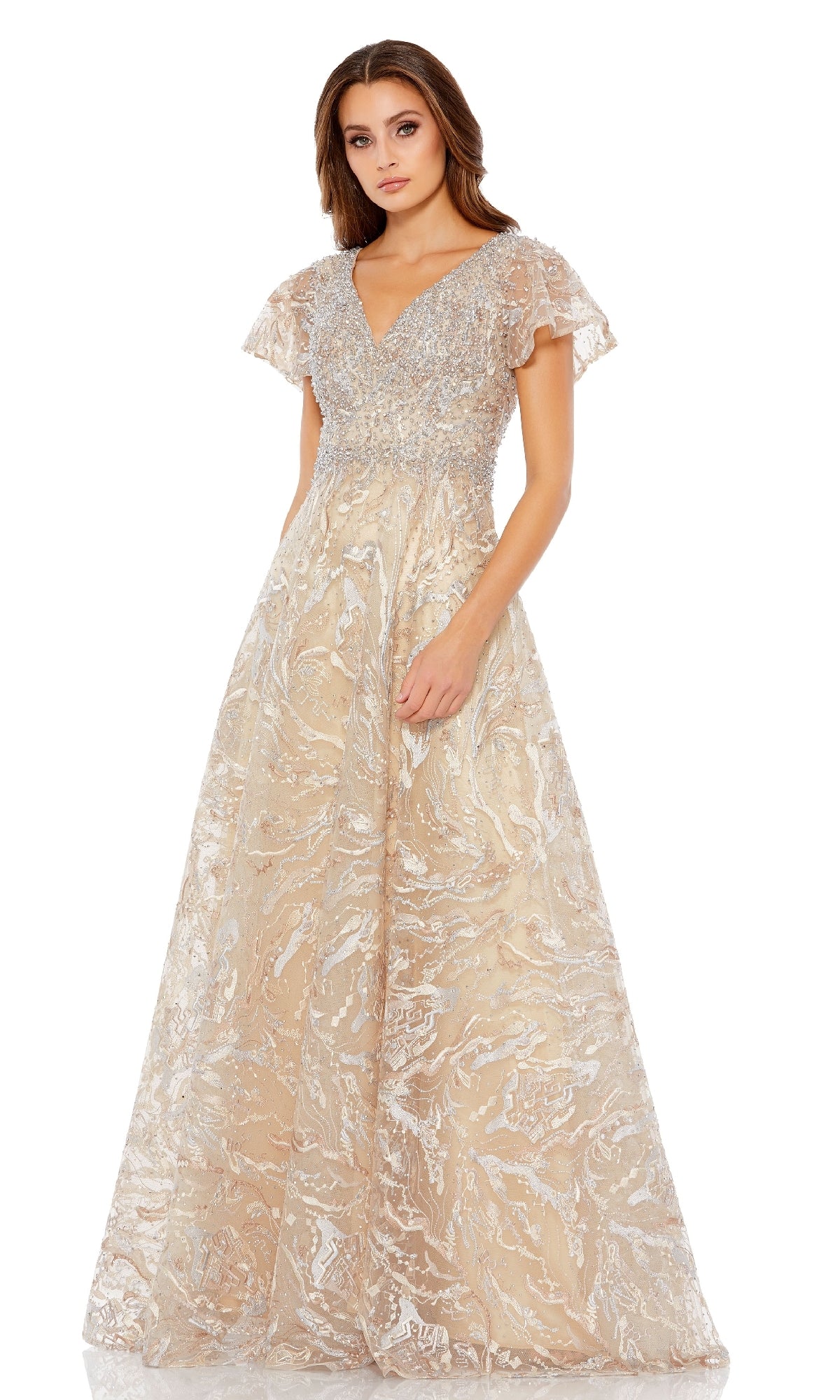 A woman stands against a white background wearing the Mac Duggal 20301 short-sleeve formal dress—an A-line evening gown in light gold with flutter sleeves, V-neckline, silver embroidery, and a beaded waist.