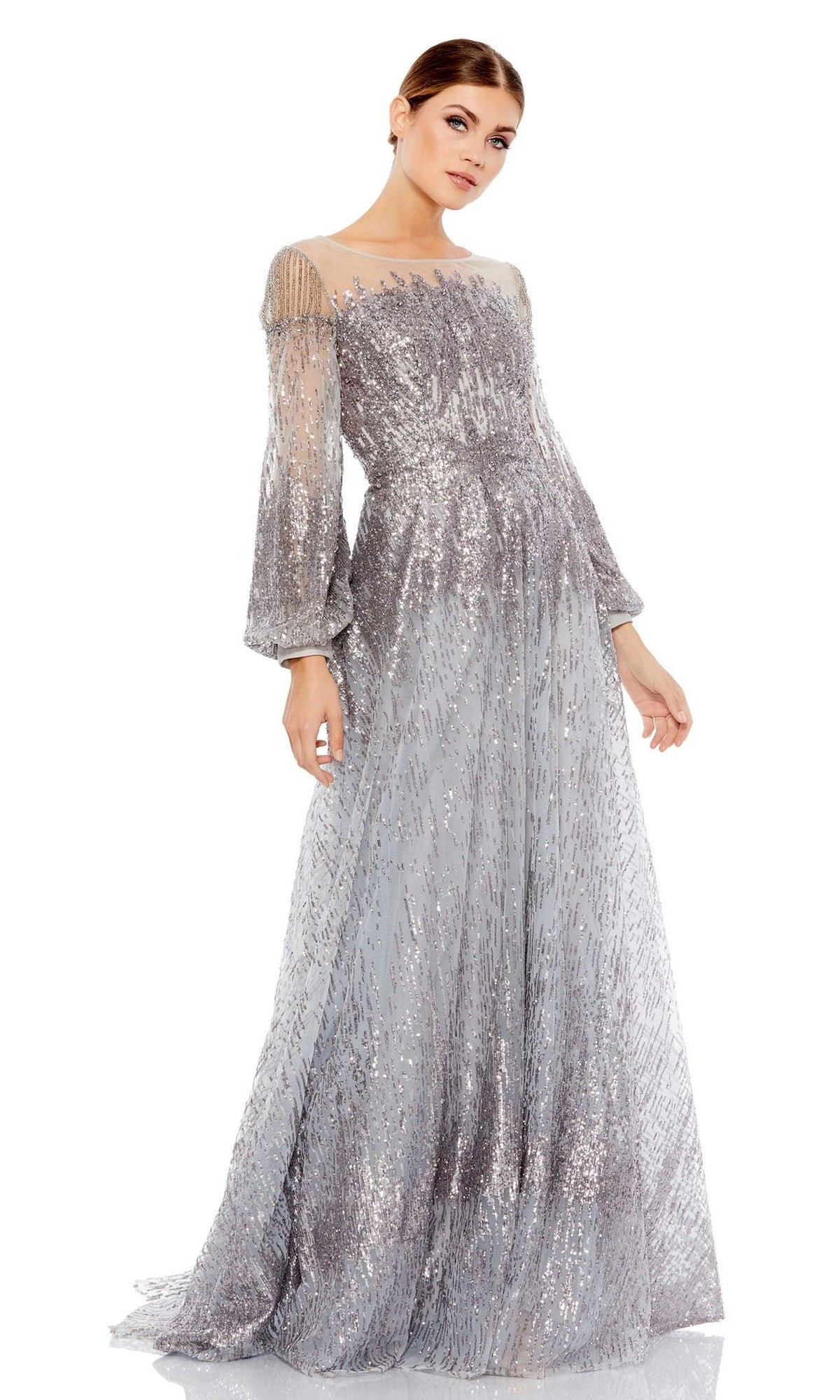 A woman poses against a white background in the Mac Duggal 20307 Long Sleeve Sequin Formal Gown, featuring sheer sleeves and a fitted bodice for an elegant, sophisticated look.
