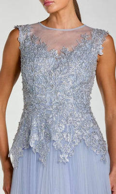 Woman wearing the Mac Duggal 20360 long formal dress, a sleeveless, light blue gown featuring intricate silver floral embroidery and a sheer neckline.