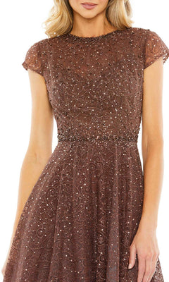 A woman wears the Mac Duggal 20371 Cap Sleeve A-Line Formal Dress—brown, short-sleeved, with beaded lace embellishments, a high neckline, and fitted waist—posed against a white background.