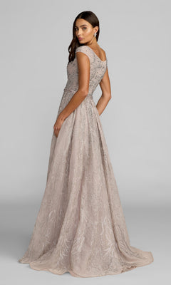 A woman stands slightly turned to the side against a plain gray background, wearing the Mac Duggal 20374 long formal dress in light mauve, featuring floor-length styling with intricate embroidery and beaded embellishments.