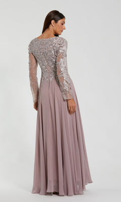 A woman faces away, wearing the Mac Duggal 20388 Long Sleeve Special Occasion Dress with chiffon fabric, sheer silver-embroidered lace sleeves and back, and a flowing mauve skirt.