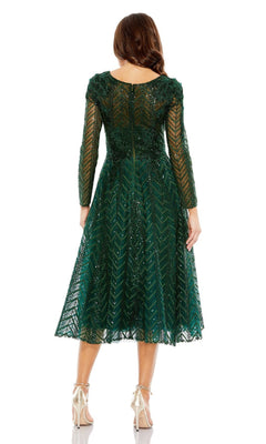 A woman faces away, wearing the Mac Duggal 20399 long sleeve midi party dress in emerald green lace with a knee-length hem, paired with beige high heels.