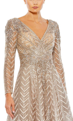 A model wears the Mac Duggal 20399 Long Sleeve Midi Party Dress, featuring a V-neck, semi-formal style with silver sequins and intricate patterns, shown from shoulders to mid-thigh against a white background.