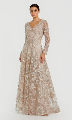 A woman stands against a plain white background wearing the Mac Duggal 20409 long formal dress in champagne, featuring lace embroidery, an A-line silhouette, long sleeves, and a V-neckline.