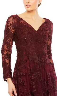 A woman wears the Mac Duggal 20409 long formal dress, featuring dark red lace, intricate floral embroidery, and bead detailing, shown from shoulders to mid-thigh.