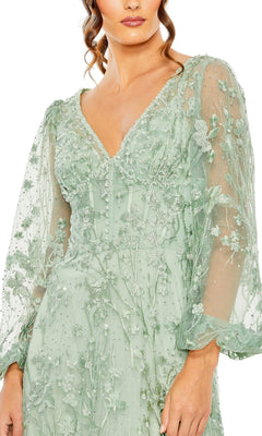 A woman wearing the Mac Duggal 20430, a light green sheer long sleeve formal dress with embroidered floral patterns and a V-neckline.