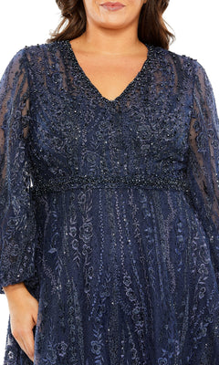 A woman wearing the Mac Duggal 20472 long plus-size formal dress in navy blue, featuring beaded lace, elegant long sleeves, a V-neckline, and intricate floral embroidery; shown from shoulders to mid-thigh.
