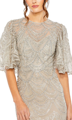 A woman wears the Mac Duggal 20481 Flutter-Sleeve Taupe Formal Gown, showcasing intricate sequin and bead embellishments in a scalloped pattern—an elegant choice for any special evening occasion.