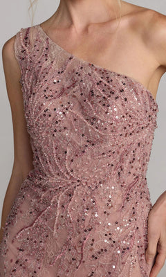 A person wearing the Mac Duggal 20482 Long Formal Dress, featuring a one-shoulder design in blush pink with embellished lace and sparkling sequins.