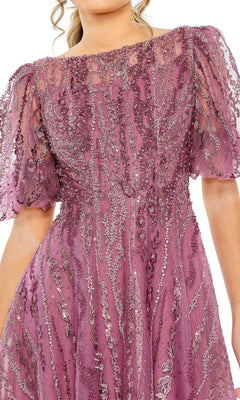 Wearing the Mac Duggal 20485: an embroidered mauve wedding-guest dress with sheer short puff sleeves and intricate swirling sequin and bead embellishments.