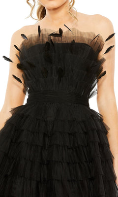 A woman in the Mac Duggal 20529 Strapless Ruffle Party Dress, featuring layered tulle ruffles and black feather accents on the bodice.