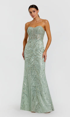 A woman wears the Mac Duggal 20544 Strapless Long Beaded Prom Dress—an elegant, floor-length, light green gown with silver sequin details—standing against a plain white background, perfect for special occasions.