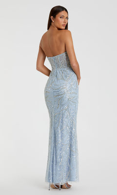 A woman faces away from the camera in a strapless, light blue, beaded Mac Duggal 20544 prom dress, highlighting its elegant design against a plain white background.