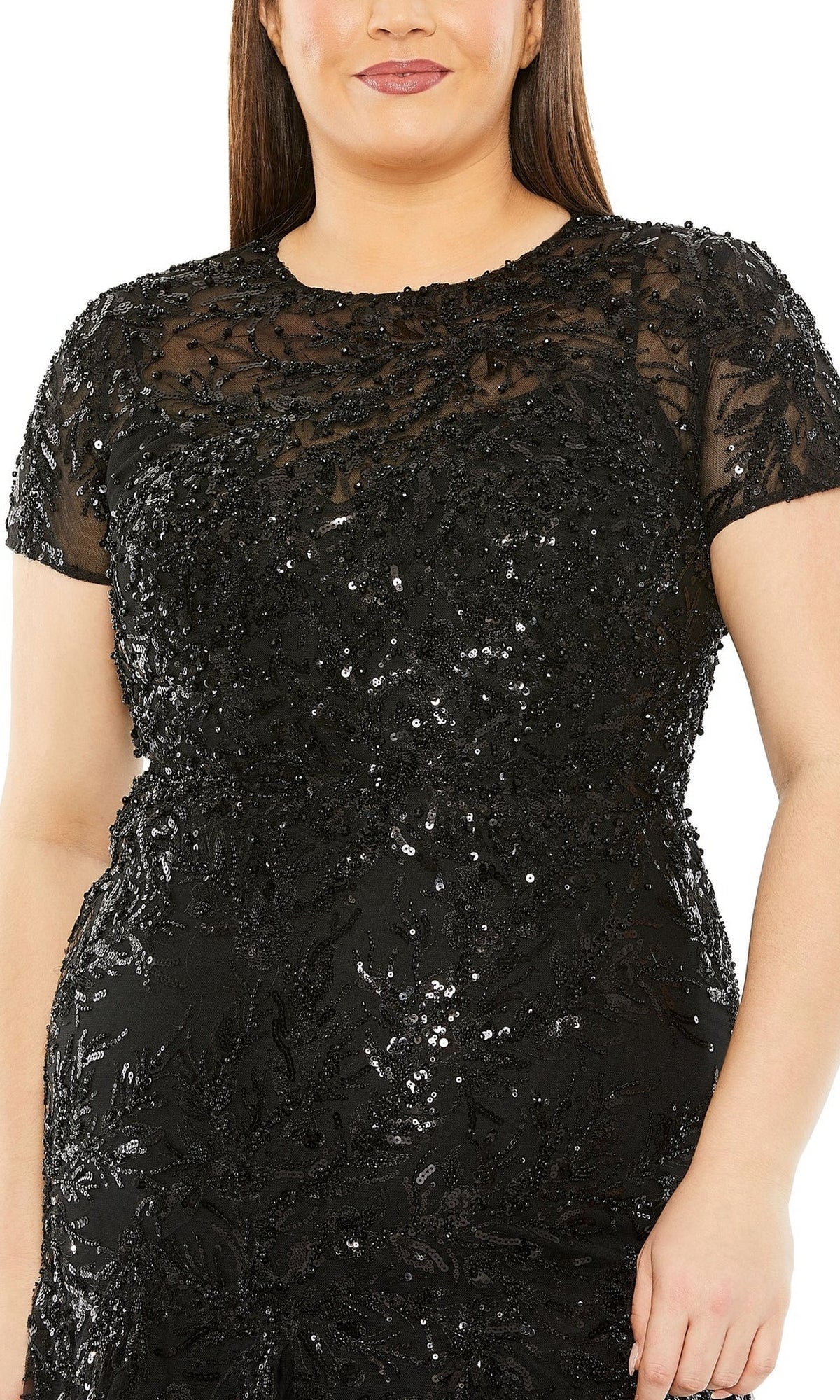 Wearing the Long Plus-Size Prom Dress 20623 by Mac Duggal, a black high-neck dress with short sleeves, sequin and bead embellishments, and a sheer overlay on the upper bodice.