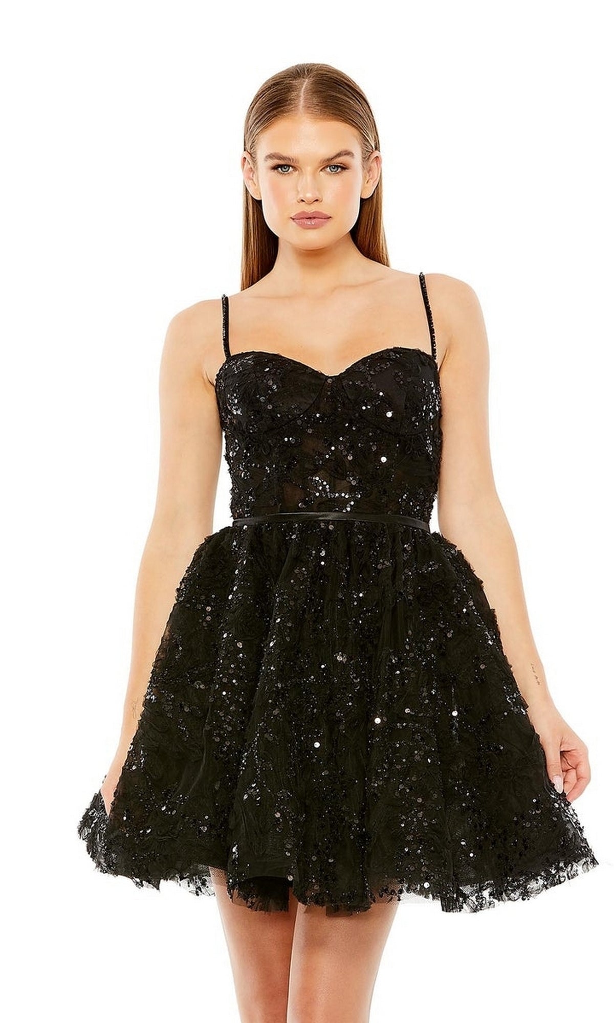 Woman in the Mac Duggal 20641 Short Black Beaded Hoco Dress with a sweetheart neckline, thin straps, flared skirt, and subtle sequins, posing against a plain white background.